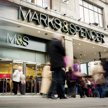 Marks & Spencer department store, Oxford Street, London. Blurred shoppers walking past the flagship M&S store in the heart of London's shopping district.