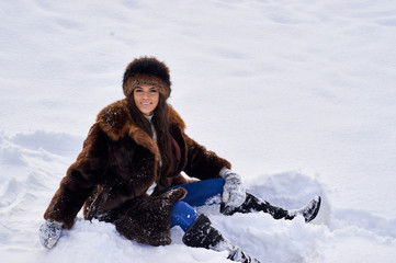 Fototapeta na wymiar Young girl enjoying snow outdoors in winter.