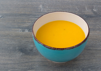 Cream of pumpkin soup with pumpkin seeds, parsley and dry bread