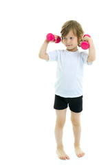 Naklejka premium Little girl doing exercises with dumbbells.