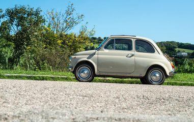 Vintage beige color car. Small old car. Italian car.