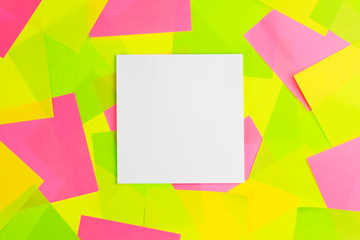 The white paper note put on colorful sticky note background.