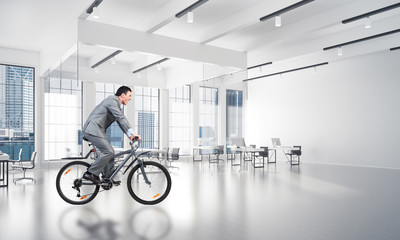 Businessman wearing business suit riding bicycle