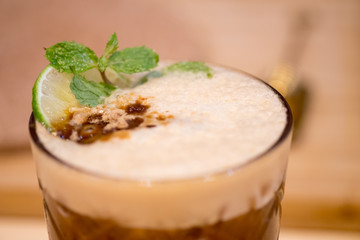 Espresso, mint and lime cocktail in a glass.