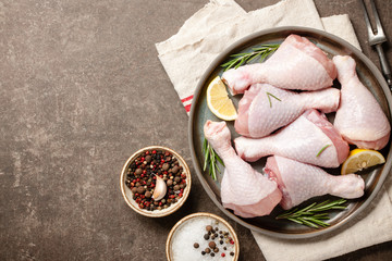 Fresh raw chicken legs with ingredients for cooking