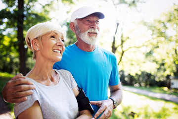 Fitness, sport, people, exercising and lifestyle concept - senior couple running