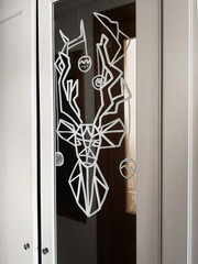 Pattern of a beautiful silhouette drawing of a reindeer, drawn on a mirror