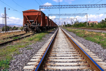 Fototapeta na wymiar Railway road and old freight cars on background.