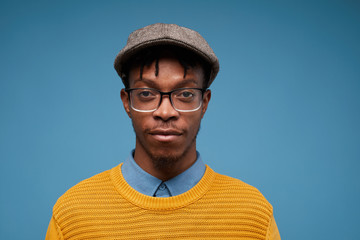 Head and shoulders portrait of contemporary African-American man looking at camera while wearing...