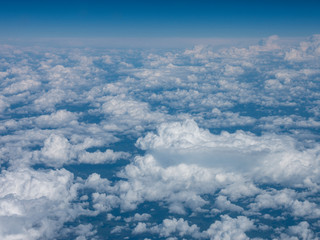 blue sky above clouds from airplane window