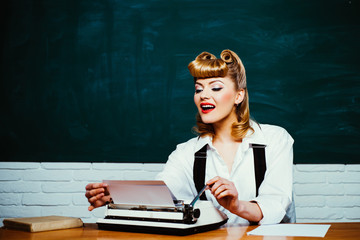 Romantic letter. Beautiful girl is typing on an old typewriter. Retro style.