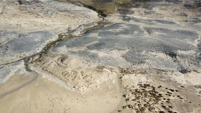 Aerial, drone shot, panning over sand and details, on the Breidavik beach, on a sunny day, in Westfjords, Iceland