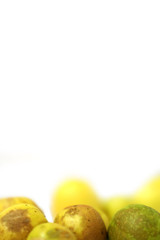 fresh and green lemon with tainted lemon on a white background