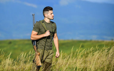 Man observing nature background. Hunter hold rifle. Natural environment. Hunter spend leisure...