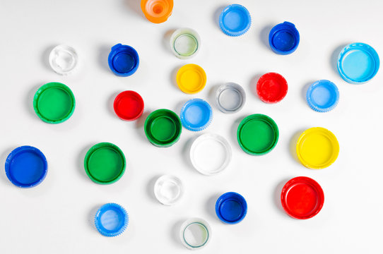 multicolored plastic stoppers on white background