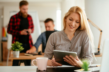 Young businesswoman using tablet in the office
