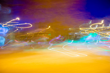 Abstraction of the night city. Glowing chaotic stripes on a black background.