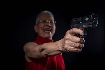 Old lady aiming with her weapon while smiling