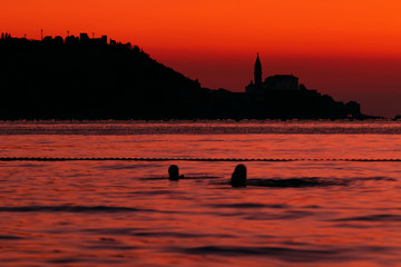 Sunset swimming with scenery of Piran church in slovenia