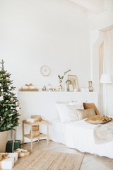 Modern interior design bedroom with Christmas / New Year decorations, toys, gifts, fir tree. Winter holidays composition.