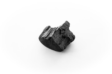 Obraz premium black charcoal on white background. a porous black solid, consisting of an amorphous form of carbon, obtained as a residue when wood, bone, or other organic matter is heated in the absence of air.