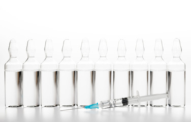 Glass medicine ampoules and Syringe on white background