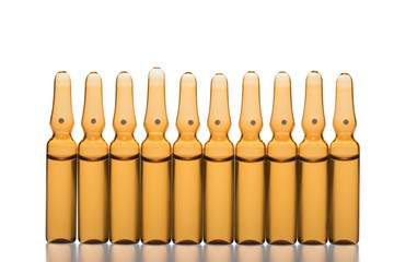 Glass medicine ampoules on a white background
