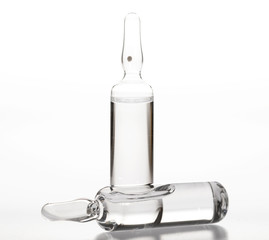 Glass medicine ampoules on a white background