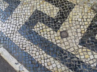Background texture of the Typical portuguese walkway pavement with old stone in the streets of Lisbon, Portugal