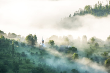 Beautiful scenery landscape sunrise foggy morning village Maramures Romania 