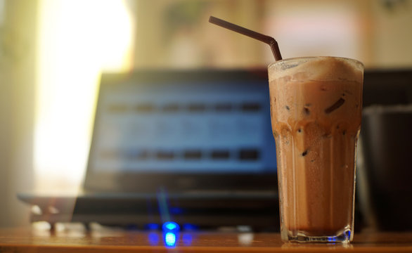 A Glass Of Iced Coffee On Office Table