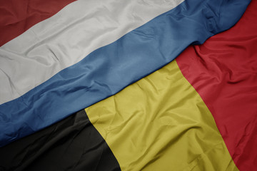 waving colorful flag of belgium and national flag of luxembourg. - obrazy, fototapety, plakaty