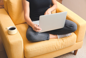 Young woman working on laptop at home