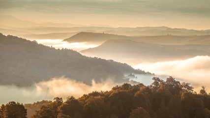 Beautiful scenery landscape sunrise foggy morning village Maramures Romania 