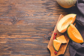 Composition with sweet ripe melon on wooden background