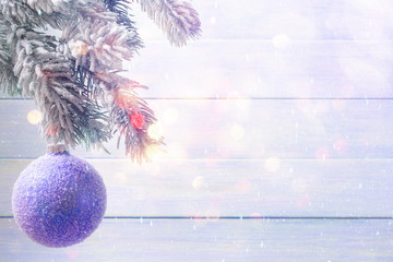 Blue Christmas ball hanging on frosty branch. Xmas and New Year concept