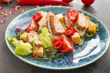 Plate with tasty salad on table