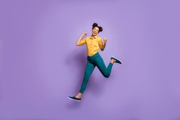 Fototapeta na wymiar Full body profile photo of pretty dark skin lady jumping high celebrating favorite football team victory wear casual yellow shirt trousers isolated purple color background