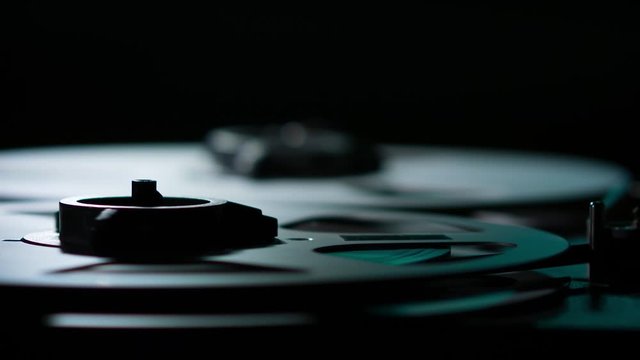  Retro Analog Quarter Inch Tape Recorder Being Operated in a Darkened Room