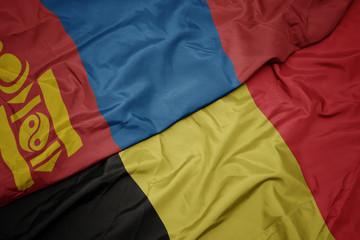 waving colorful flag of belgium and national flag of mongolia.