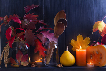 Autumn leaves, pumpkins, wooden spoons on black background. Thanksgiving autumn concept. Cozy autumn season food menu concept