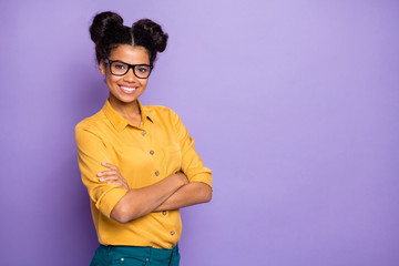 Photo of amazing dark skin lady holding arms crossed positive mood bossy self-confident look wear specs yellow shirt isolated purple color background