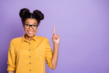 I have plan. Photo of amazing dark skin lady indicating finger empty space intelligent person creative idea wear yellow shirt isolated purple color background