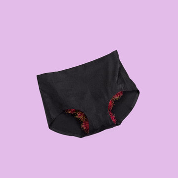 Brazilian wax symbol with rambutan and black underwear on purple background