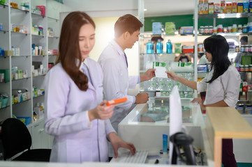 Pharmacist man takes the order of medicine prescription from customer in pharmacy store