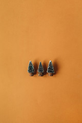 Tree toy Christmas fir-trees on ginger background. Flat lay, top view Christmas / New Year minimal...