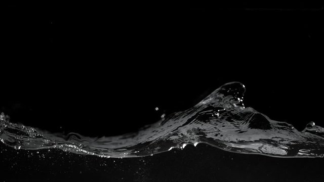 Super slow motion of splashing water isolated on black background. Filmed on high speed cinema camera, 1000 fps.