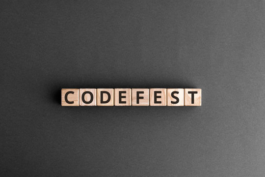 Codefest - word from wooden blocks with letters, hackathon a hack day, hackfest or codefest concept,  top view on grey background