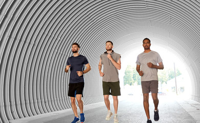 fitness, sport and healthy lifestyle concept - young men or male friends running outdoors