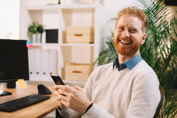 Businessman using phone in office